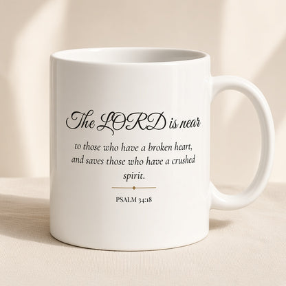 Psalm 34:18 The LORD Is Near mug front view on cream linen