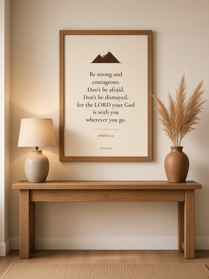 Joshua 1:9 Bible verse print in an oak frame above an entryway table